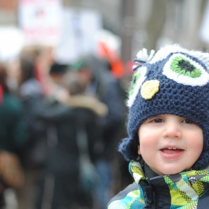 This cutie was sitting atop his dad's shoulders watching the crowd go by.