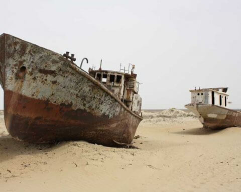 The world’s lakes and freshwater are in peril | An image of a boat in a dried up lake
