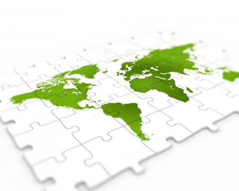 Green world map on puzzle