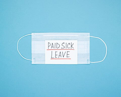 Surgical mask with "paid sick leave" note