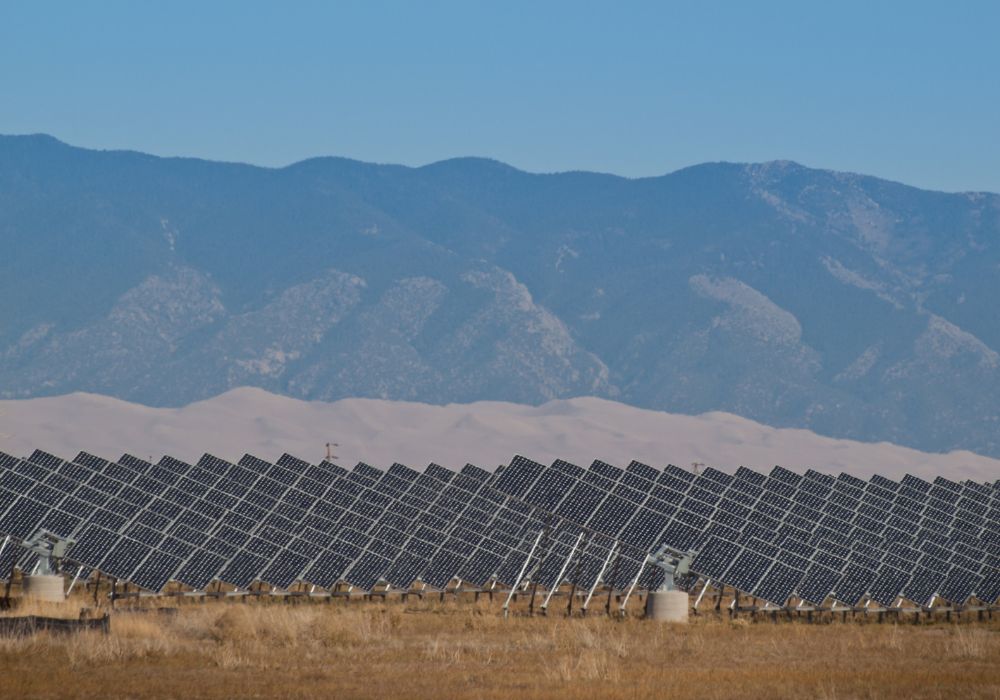 A series of large solar panels forms a symmetrical line at a power plant in Colorado.